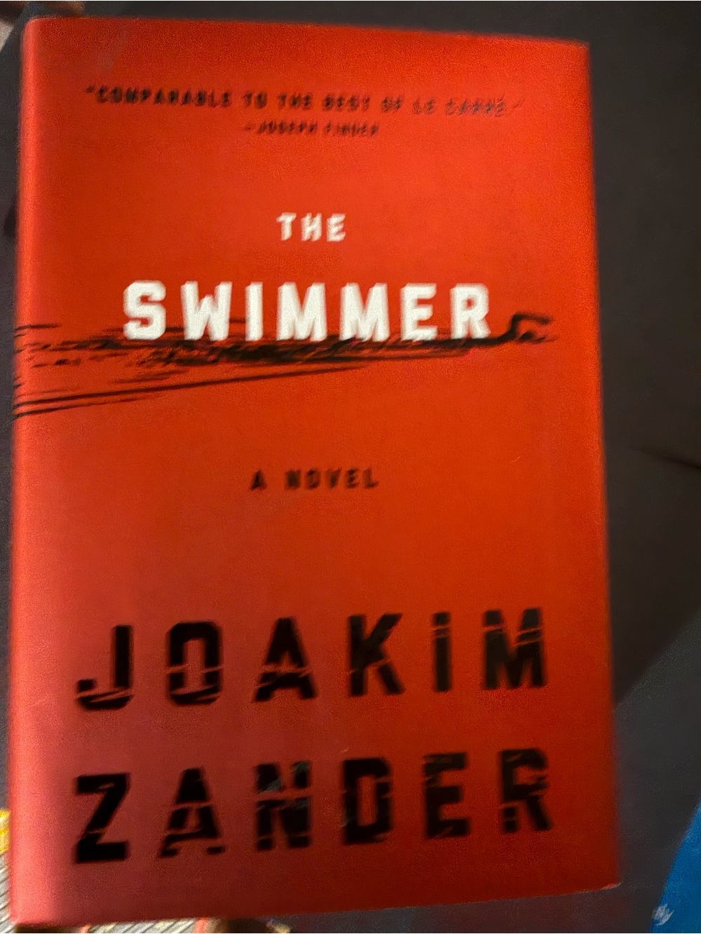 The Swimmer by Joakim Zander - Red Hardcover Novel